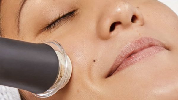 Facial treatment device applied to cheek.